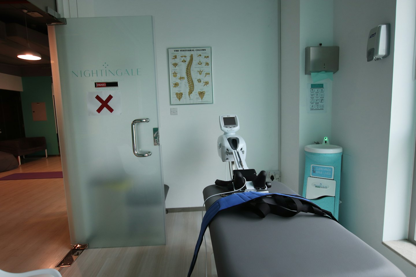 Therapy room with treatment table and spinal device.
