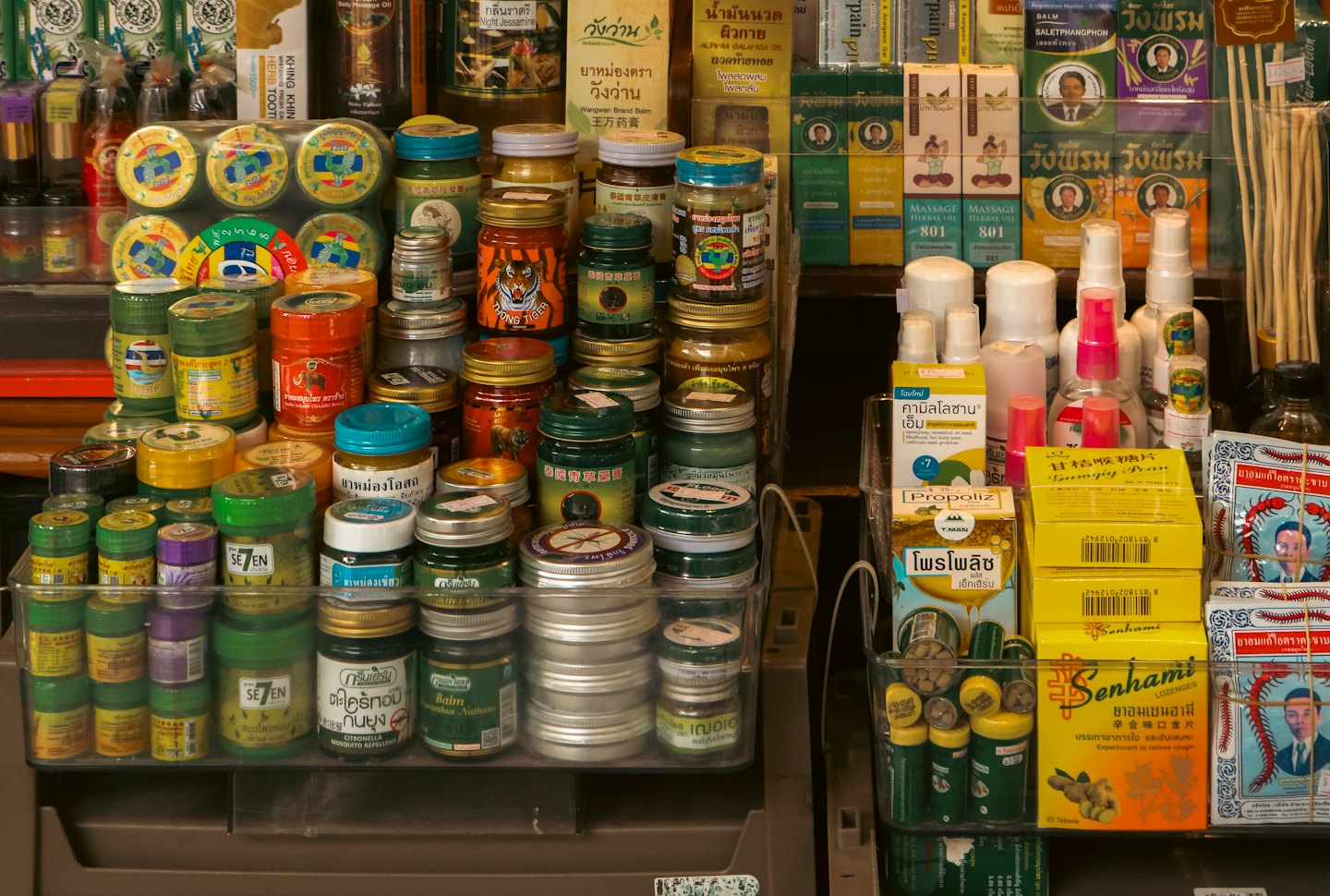 Asian herbal remedies and health supplements displayed on shelves.